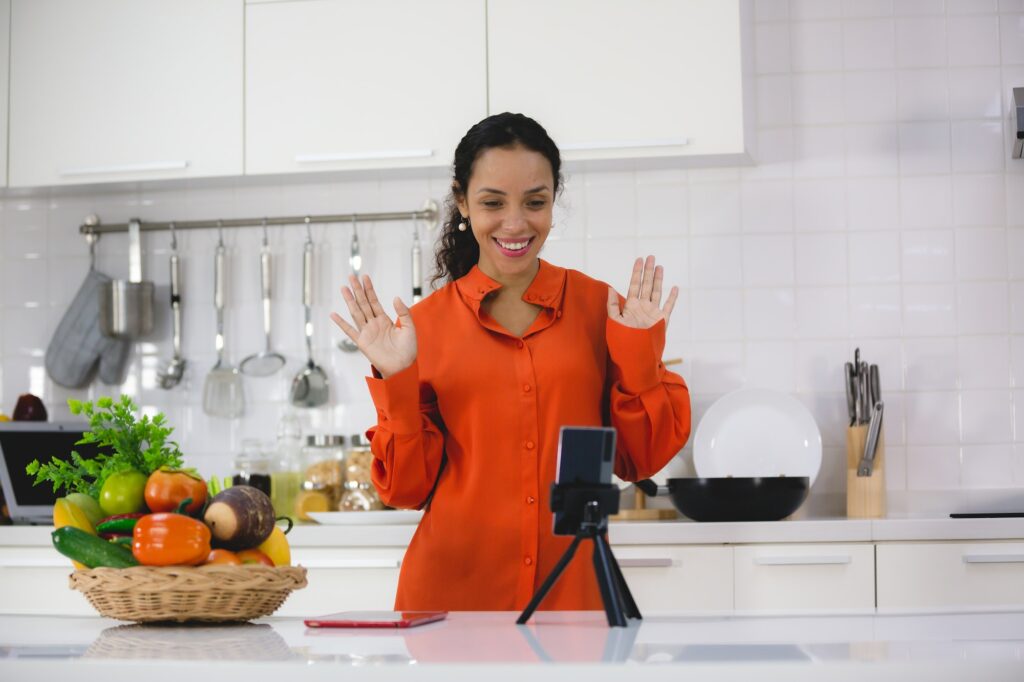 African American woman happy and fun to cooking healthy food in home kitchen, online cook learning